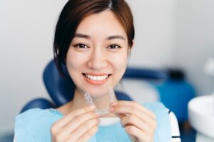 Girl smiling and holding mouth guard